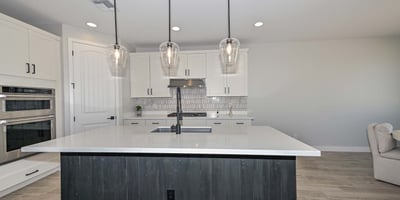Enjoy cooking in style with premium stainless appliances, an oversized island, chic pendant lights, and designer tile backsplash.
