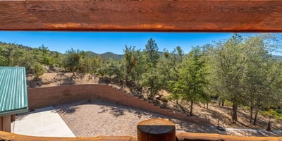 Deck space capturing tranquil pine views and open skies, offering a peaceful outdoor extension of the home.