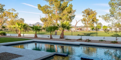 A sparkling pool with lush golf course views creates the perfect backyard oasis for this Scottsdale home, blending relaxation with elegance.