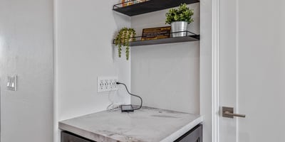 Built-in storage and charging station keep electronics organized, adding smart functionality to this Scottsdale home.