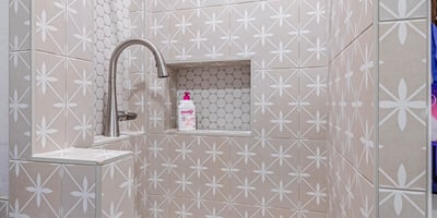 Stylish tiled dog wash with sink and storage makes pet care practical, adding to the Scottsdale home s modern upgrades.