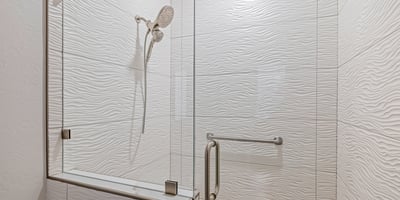 A frameless glass shower with textured wall tile and updated fixtures highlights the hall bath s modern upgrades.