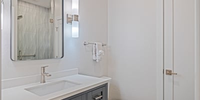 Connected directly to the bedroom, this en-suite bathroom boasts a modern vanity, quality finishes, and a fresh, contemporary design.
