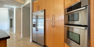 Sleek kitchen featuring premium stainless appliances and warm maple cabinetry combining efficiency with contemporary Scottsdale design.