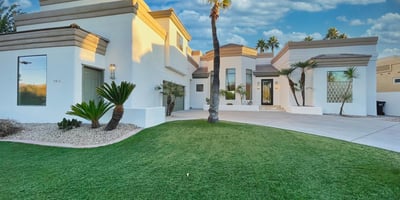 Eye-catching architectural design featuring pristine white exterior, tiered rooflines, and lush greenery for stunning curb appeal.