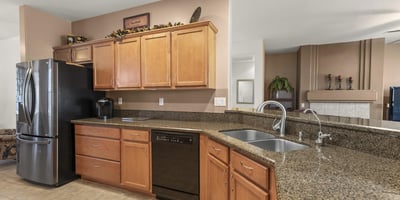 Enjoy a kitchen that blends warmth and practicality, offering expansive countertops, ample cabinets, and a seamless connection to the main living area.