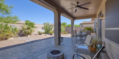 Enjoy peaceful mornings or evening sunsets in this private, low-maintenance backyard featuring native plants and decorative pavers.