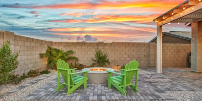 Soft lighting and thoughtful landscaping bring this backyard to life at dusk. The spacious layout and turf area offer inviting, low-maintenance outdoor living in Litchfield Park.