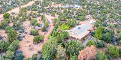 This sweeping shot captures the vast desert landscape and dramatic mountain ridge. The perfect visual representation of the tranquility and beauty surrounding this Hackberry property.