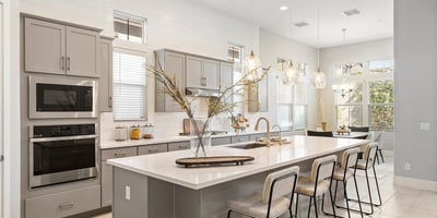 Oversized island kitchen designed for gathering, complete with pendant lighting, quartz surfaces, and comfortable seating.