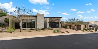 Modern home exterior with minimalist architecture and low-maintenance desert landscaping. Designed for buyers seeking upscale Scottsdale living with strong curb appeal.