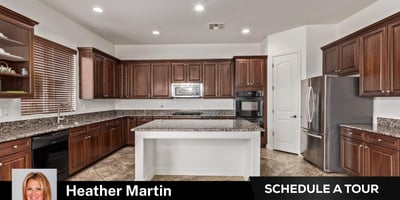 The large island and expansive granite surfaces provide ample workspace for cooking and entertaining. Rich cabinetry and built-in appliances enhance this Glendale property s appeal.
