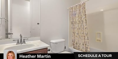 This clean and functional guest bathroom includes a full tub and shower, extended vanity, and wood cabinetry. A practical addition to this well-maintained Glendale home for sale.