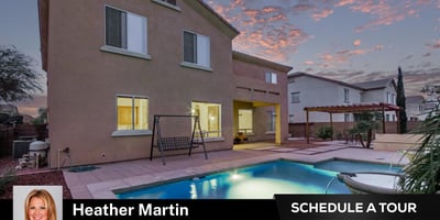 Evening lighting showcases the inviting covered patio and shimmering pool. Designed for entertaining, this Glendale home offers seamless indoor-outdoor flow and energy-efficient comfort.
