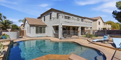 Resort-inspired backyard with freeform pool, raised spa, and spacious decking ideal for relaxing, swimming, and entertaining guests.
