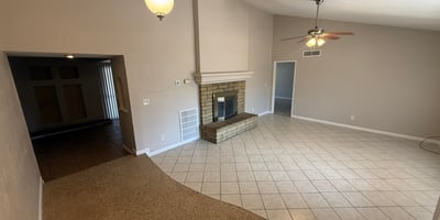 Bright Glendale living room with classic fireplace, tile flooring, and spacious layout. The room offers plenty of space for gatherings and everyday living.