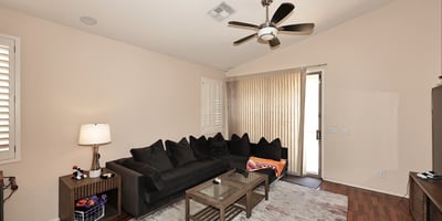 Light-filled living room with large windows and sliding door to outdoor space. This Phoenix home offers great indoor-outdoor flow.