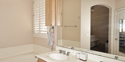 Primary bath with dual vanities, soaking tub, and abundant counter space. This Phoenix home features practical design, natural light, and comfortable finishes.