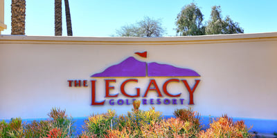 The Legacy Golf Resort sign set among desert plants and clean hardscape. This Phoenix location offers access to golf, recreation, and scenic surroundings.