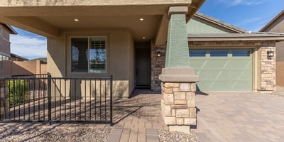 Charming front porch with architectural columns and shaded entry, creating an inviting first impression for this upgraded Peoria residence.