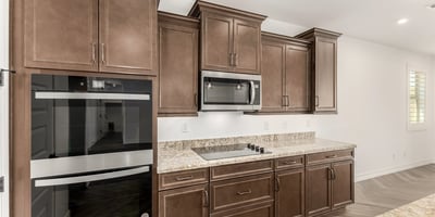 Gourmet kitchen featuring double ovens, sleek cabinetry, and premium finishes. Designed for convenience and elevated cooking experiences.