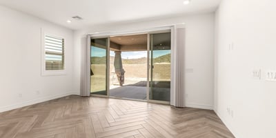 Bright family room with backyard access and open layout, creating a comfortable space for relaxing and hosting guests.