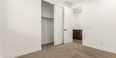 Bedroom with built-in closet and neutral design, providing flexible living space and organized storage options.