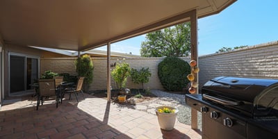 Covered patio with paver flooring and outdoor seating area, ideal for enjoying Arizona-style indoor-outdoor living.