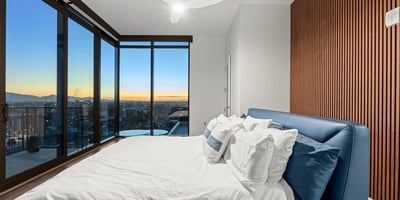 Spacious primary suite with balcony access, modern finishes, and expansive Phoenix views, offering a private and relaxing retreat.