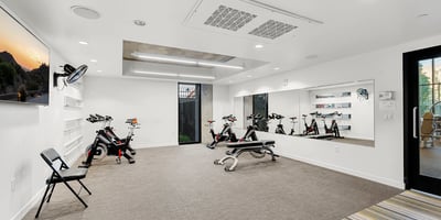 Dedicated studio for yoga and cycling, featuring mirrored walls and flexible space for wellness activities in Phoenix.