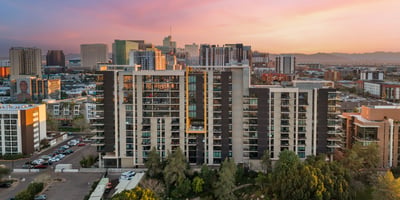 Expansive views blending city skyline with mountain backdrops at sunset, adding natural beauty to this Phoenix property.
