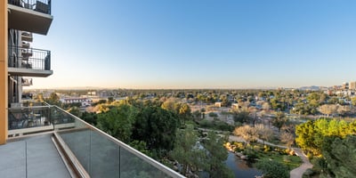 Elevated balcony overlooking landscaped park areas and walking paths, creating a peaceful outdoor space in Phoenix.