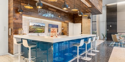 Spacious lounge with integrated bar and modern seating, designed for entertaining and relaxation in Phoenix