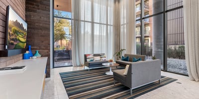 Dedicated media space with contemporary seating and large windows, ideal for entertainment and leisure in Phoenix.