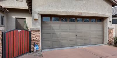 Split garage layout with gated side access and extended slab, perfect for additional parking, tools, or recreational storage in this Phoenix home.
