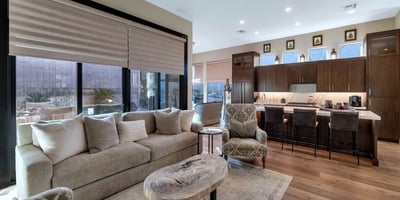 Flowing layout connecting living, dining, and kitchen spaces with abundant natural light ideal for entertaining in this Phoenix property.
