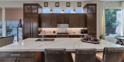 High-end kitchen featuring a Wolf gas range, custom cabinets, and quartz surfaces, perfect for culinary enthusiasts in this Phoenix home.