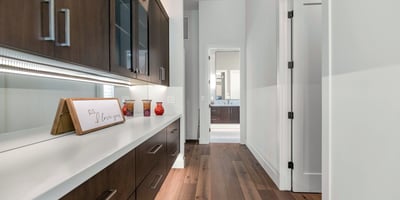 Custom hallway cabinetry with quartz countertop, adding storage and convenience to this well-designed Phoenix home.