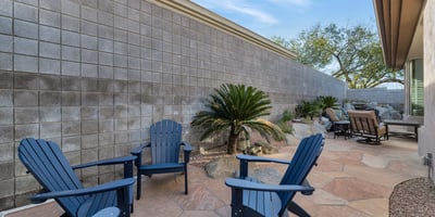 Intimate outdoor seating space with desert landscaping and privacy walls, ideal for enjoying Arizona evenings in Phoenix.