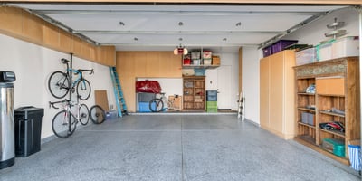 Functional garage space with built-in cabinets, storage solutions, and room for vehicles and hobbies in this Phoenix property.