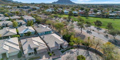 Aerial view showcasing a peaceful cul-de-sac with attractive homes, landscaped streets, and convenient access to main roads in Phoenix.
