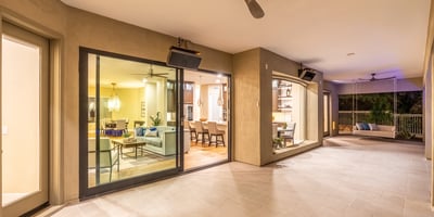 Expansive covered patio with tile flooring, ceiling fans, and sliding glass doors, creating a seamless transition between indoor comfort and Scottsdale outdoor living.
