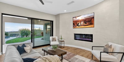 Contemporary living room with ceiling fan, neutral tones, and direct patio access, highlighting Scottsdale modern living and outdoor connection.