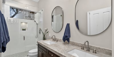 Modern Scottsdale bathroom featuring dual sinks, quartz counters, and a sleek glass shower with updated fixtures.