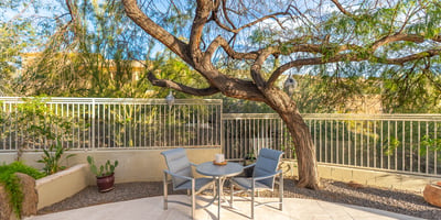 Peaceful Scottsdale garden area with patio seating, mature trees, and desert landscaping for a private outdoor retreat.