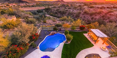 Scottsdale aerial view featuring the backyard pool, pergola kitchen, and open desert space, enhancing privacy and lifestyle appeal.