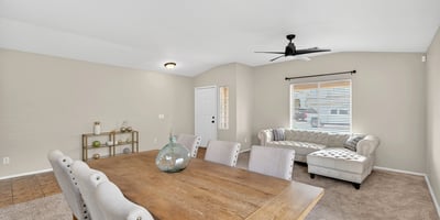 Flexible dining and living area with neutral tones and natural light. Open-concept layout enhances everyday living and entertaining in this Casa Grande home.