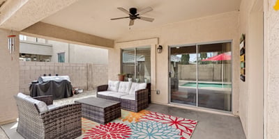 Outdoor living space with covered patio and seating area, perfect for relaxing or hosting. Easy access to the pool enhances the Casa Grande lifestyle.
