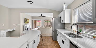 Well-designed kitchen with ample cabinets, stainless appliances, and extended counters. Open flow enhances functionality in this Casa Grande property.