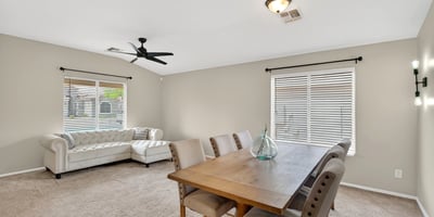 Dining area with large windows and inviting atmosphere. Ideal for gatherings and everyday meals in this Casa Grande home.